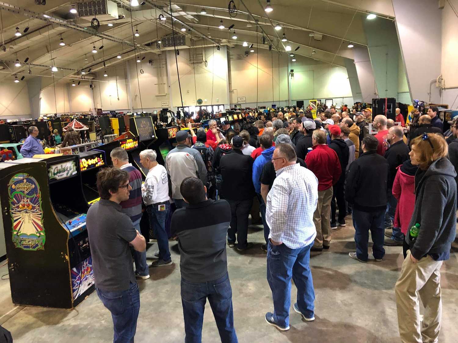 A large crowd of people at the auction game sales at the winston-salem fairgrounds in the Education Building